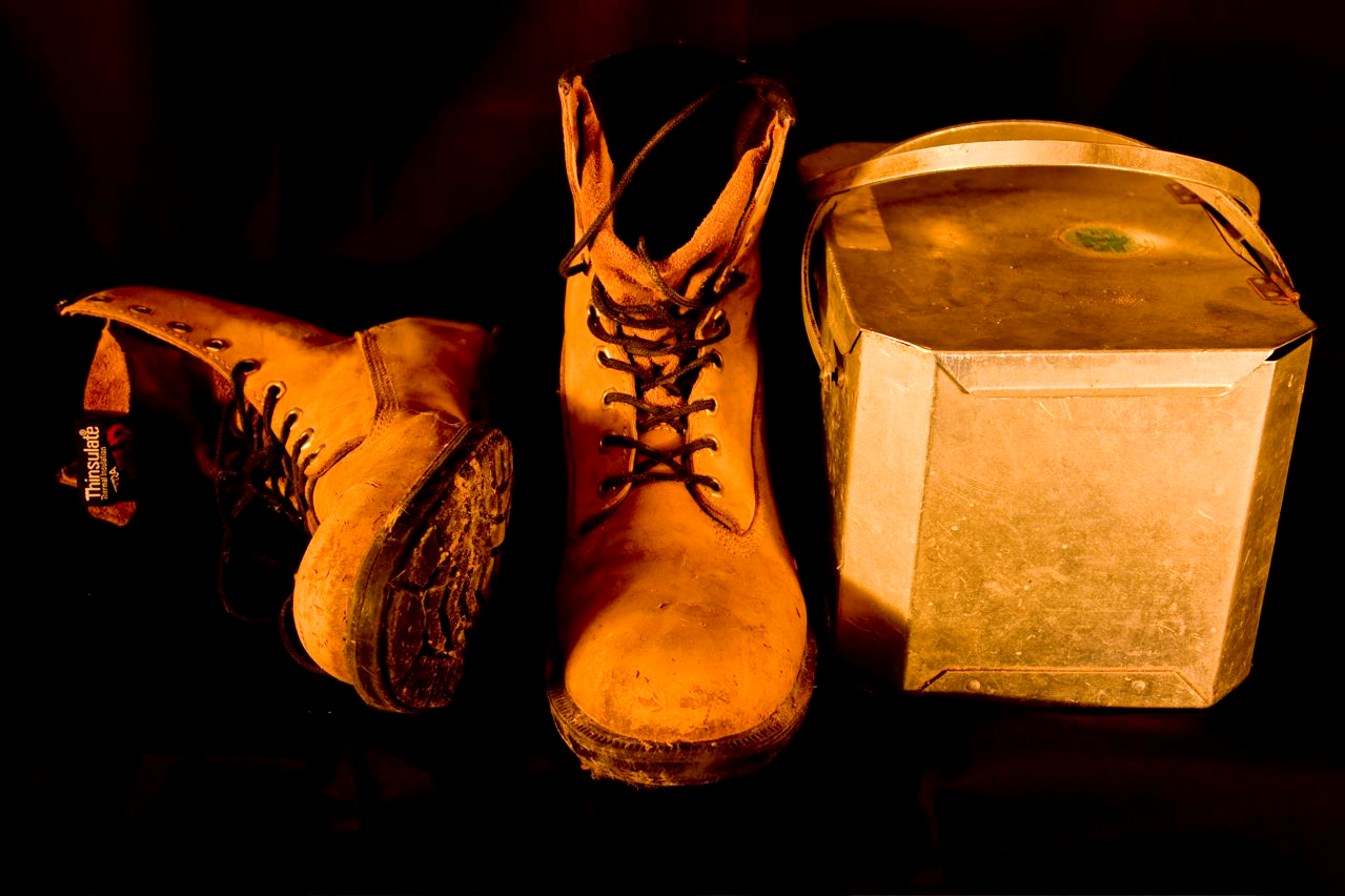 Iconic representation of mill work: steel-toed boots and aluminum lunch pail (Michael Levesque photo)